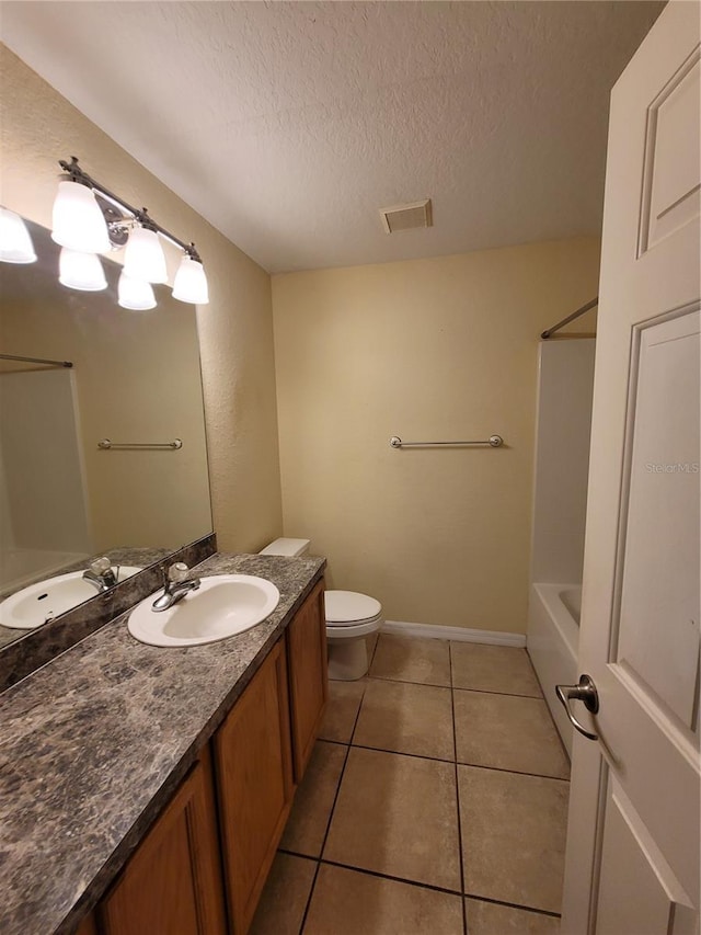 full bathroom with tile patterned floors, a textured ceiling, vanity, shower / bathing tub combination, and toilet