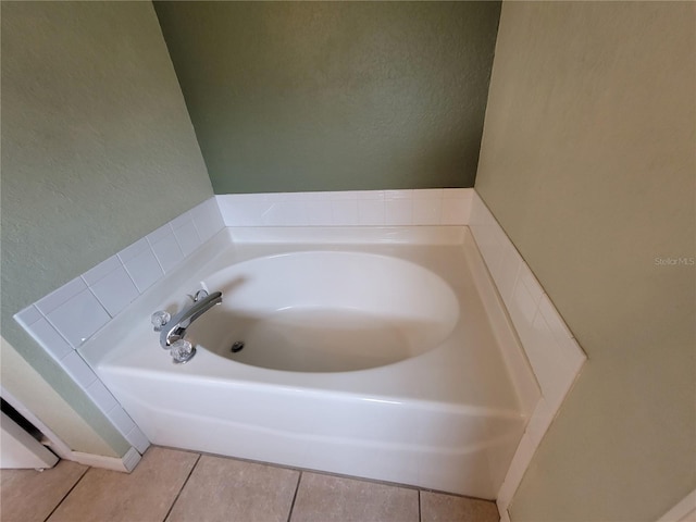 bathroom featuring tile patterned floors and a tub