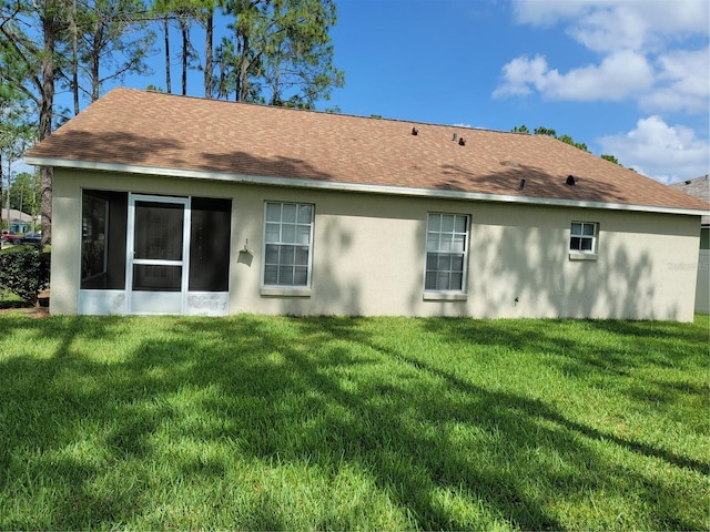 rear view of house with a lawn