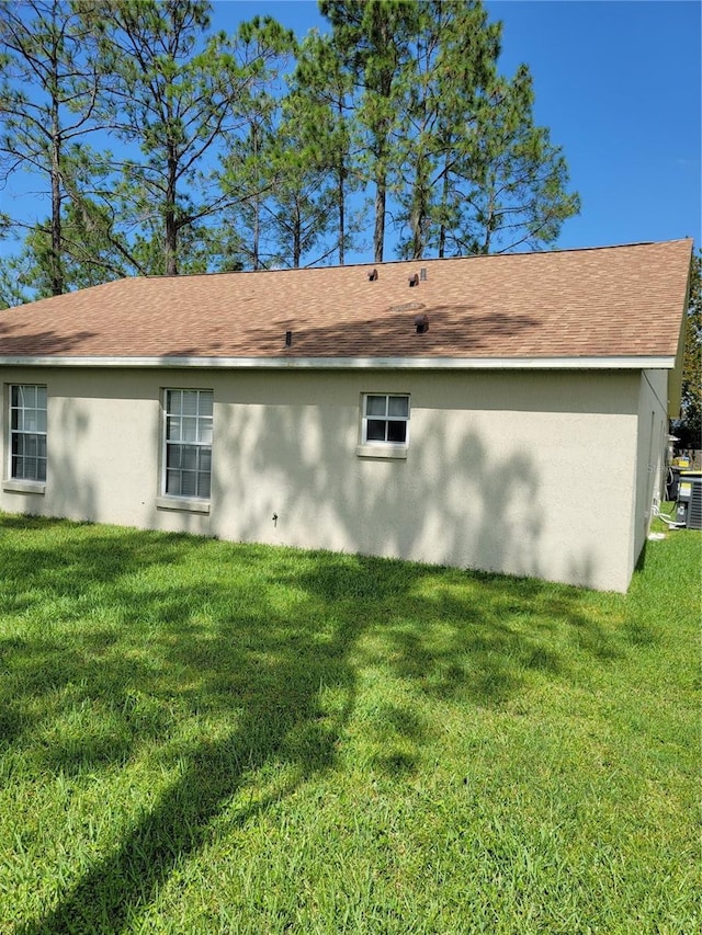 view of property exterior with a lawn