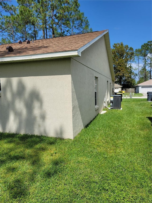 view of property exterior featuring a lawn and central air condition unit