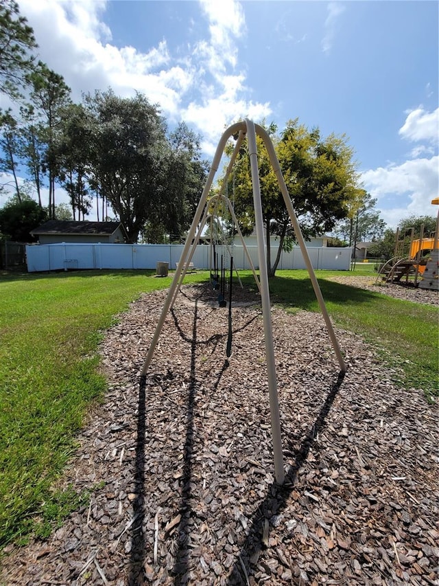 view of playground with a lawn