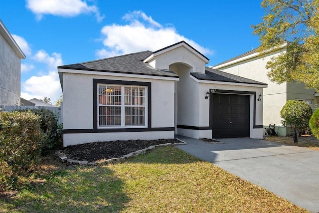 view of front of property with a garage and a front yard