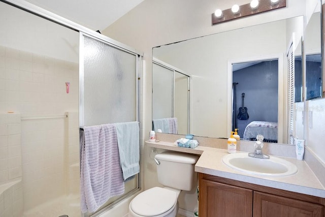 bathroom with toilet, a shower with door, and vanity