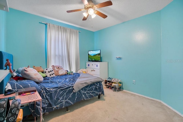 carpeted bedroom featuring ceiling fan and a textured ceiling