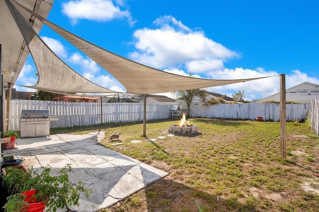 view of yard featuring a patio area and an outdoor fire pit