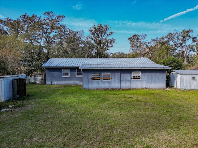 exterior space featuring a yard and a storage unit