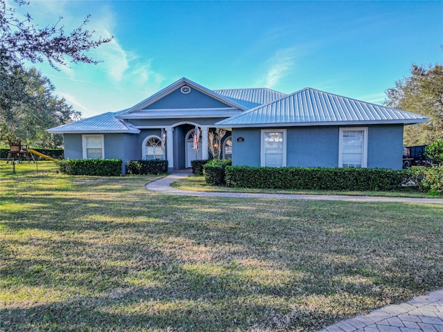 ranch-style home featuring a front yard