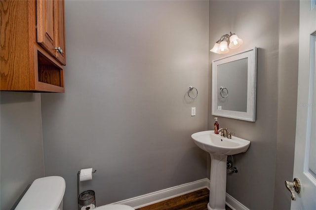 bathroom featuring hardwood / wood-style floors and toilet