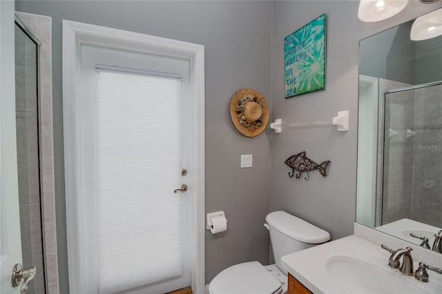 bathroom featuring vanity, toilet, and an enclosed shower