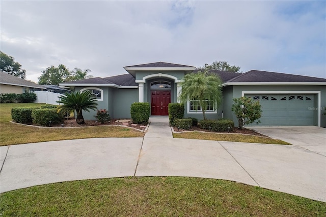 single story home with a garage and a front yard