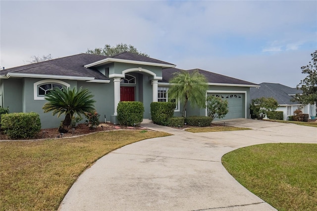 view of front of property with a garage and a front yard