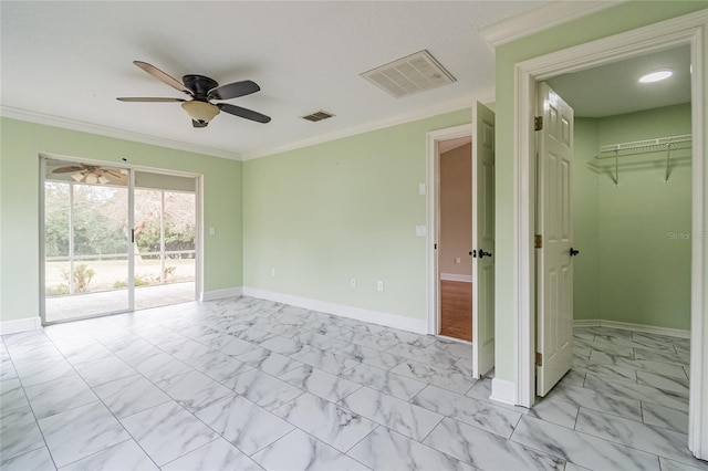 unfurnished room with ceiling fan and ornamental molding