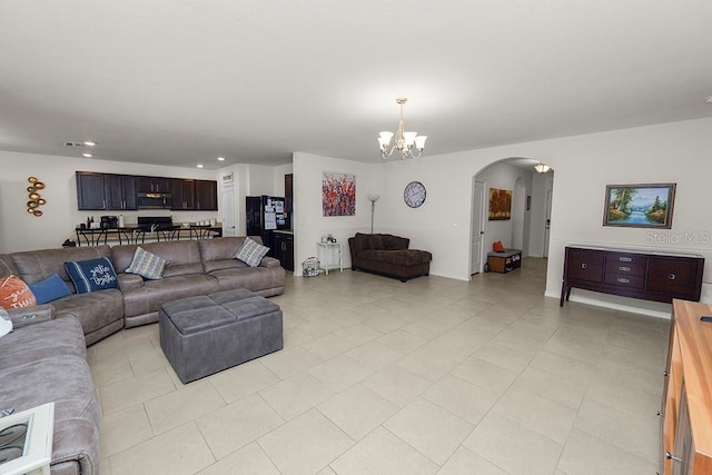 tiled living room featuring an inviting chandelier