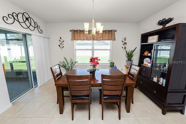 tiled dining space featuring an inviting chandelier