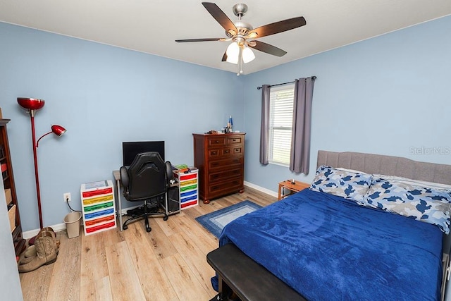 bedroom with ceiling fan and hardwood / wood-style flooring