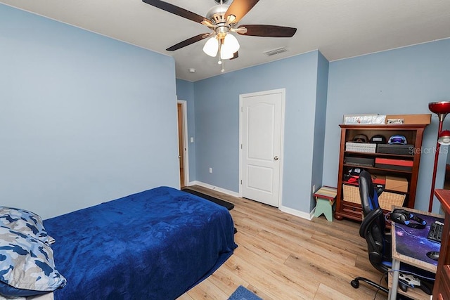 bedroom with ceiling fan and light wood-type flooring