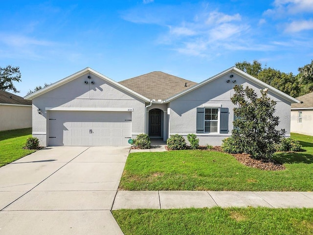 ranch-style house featuring a garage, a front yard, driveway, and stucco siding