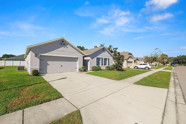 ranch-style home with an attached garage, concrete driveway, a front yard, and central air condition unit