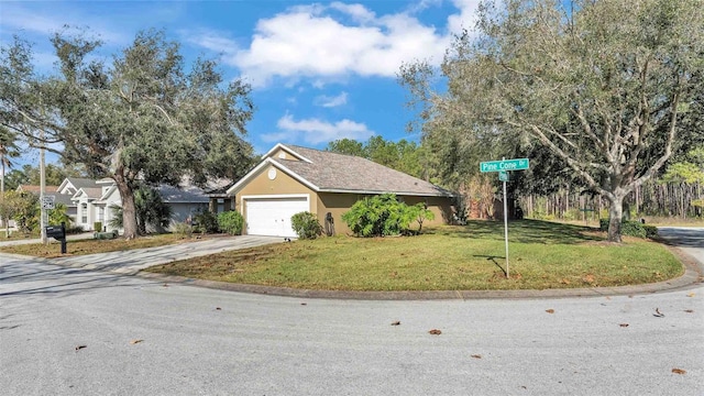 view of front facade with a garage and a front lawn