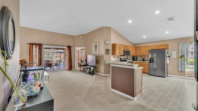 kitchen with light brown cabinets, high vaulted ceiling, light colored carpet, kitchen peninsula, and stainless steel appliances