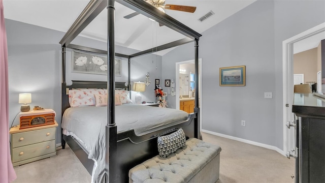 carpeted bedroom with ceiling fan, connected bathroom, and vaulted ceiling