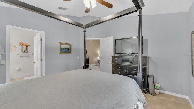 bedroom featuring ceiling fan, light colored carpet, lofted ceiling, and ensuite bath