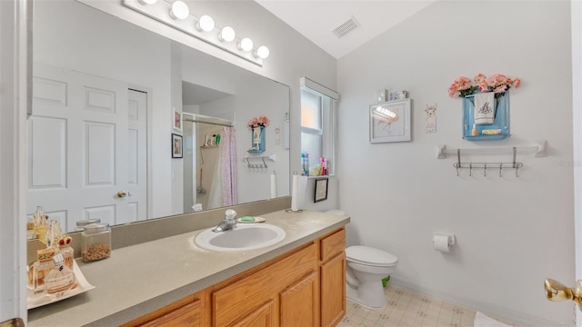 bathroom with a shower with curtain, vanity, vaulted ceiling, and toilet