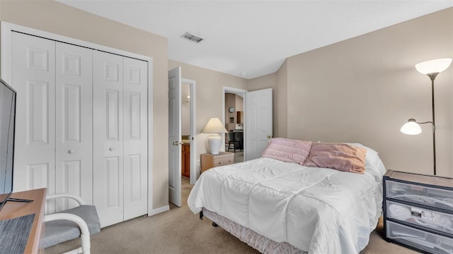 bedroom with a closet and light colored carpet