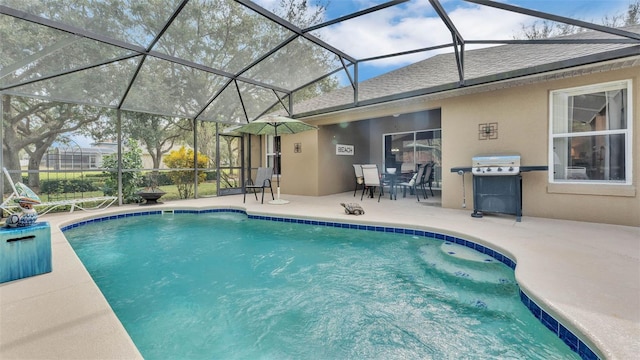 view of swimming pool featuring a lanai, a grill, and a patio area