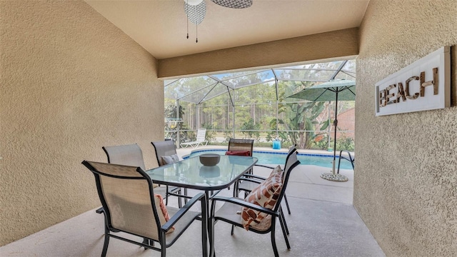 view of patio / terrace featuring glass enclosure and ceiling fan