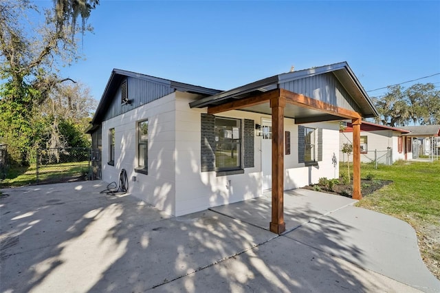 rear view of house with a patio area and a lawn