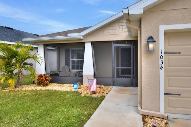 property entrance featuring a lawn