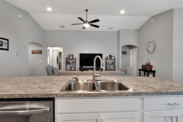 kitchen with sink, white cabinets, and vaulted ceiling