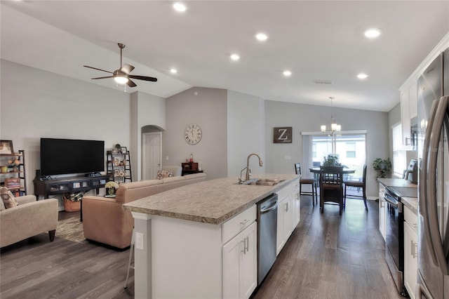 kitchen featuring sink, an island with sink, vaulted ceiling, white cabinets, and appliances with stainless steel finishes