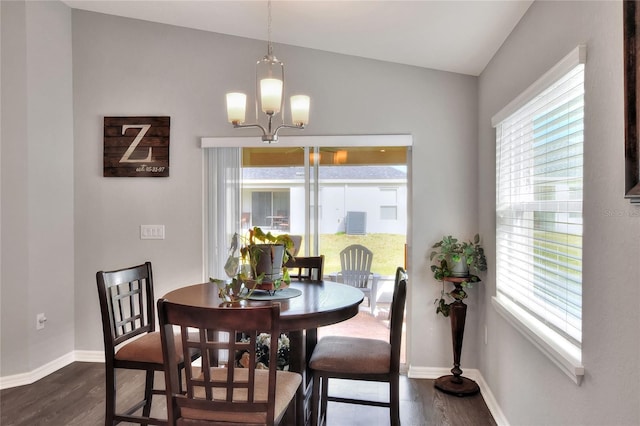 dining space featuring dark hardwood / wood-style flooring and a notable chandelier