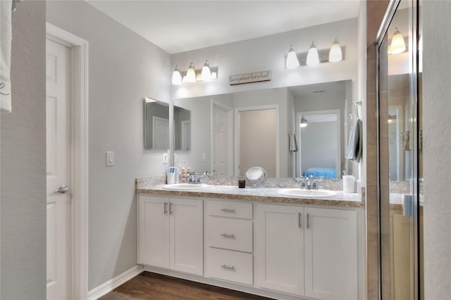 bathroom featuring hardwood / wood-style floors, vanity, and walk in shower