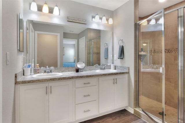 bathroom featuring hardwood / wood-style floors, vanity, and walk in shower