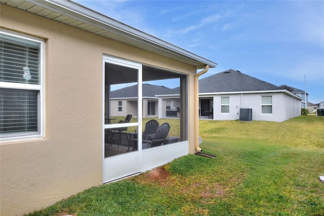 view of yard with cooling unit and a sunroom