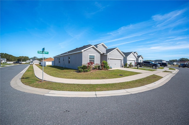 view of front of property with a front yard and a garage