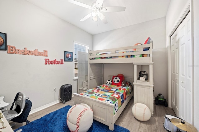 bedroom featuring ceiling fan, light wood-type flooring, and a closet