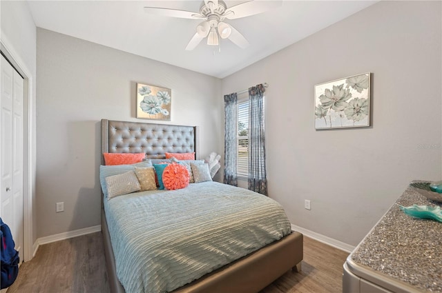 bedroom featuring ceiling fan, a closet, and hardwood / wood-style flooring