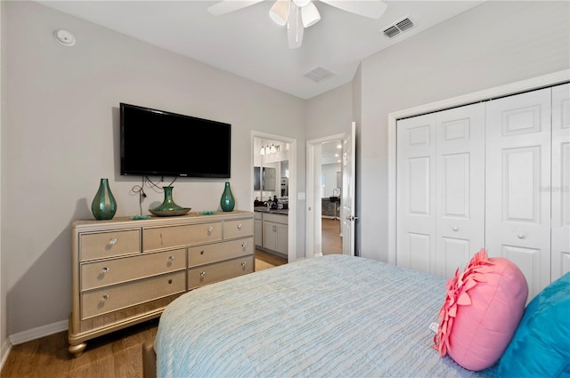 bedroom with ceiling fan, a closet, dark hardwood / wood-style floors, and ensuite bath