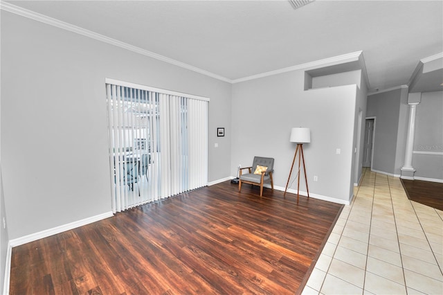 unfurnished room featuring light tile patterned floors and crown molding