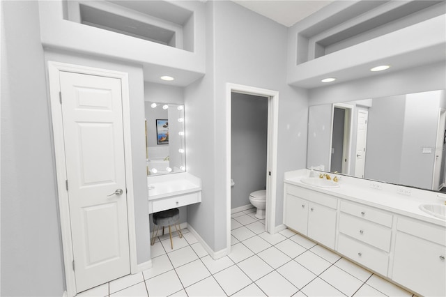 bathroom with vanity, tile patterned floors, a towering ceiling, and toilet