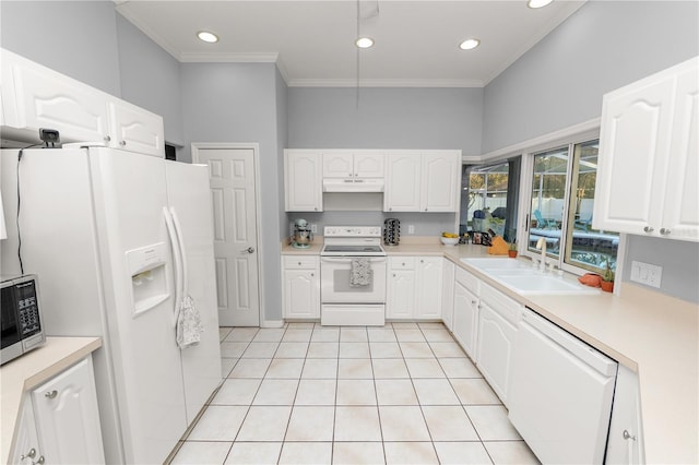 kitchen featuring sink, white cabinets, and white appliances