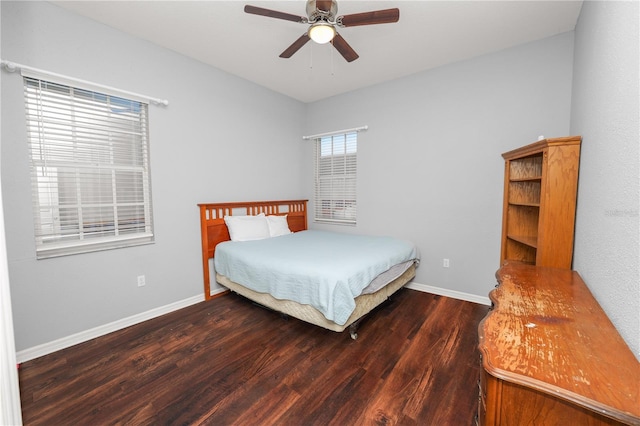 bedroom with dark hardwood / wood-style floors and ceiling fan