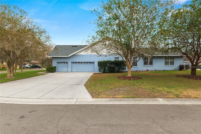 view of front of home with a front lawn and a garage