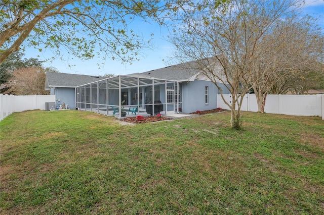 back of property featuring a fenced in pool, glass enclosure, and a yard