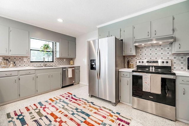 kitchen with light speckled floor, stainless steel appliances, a sink, and under cabinet range hood